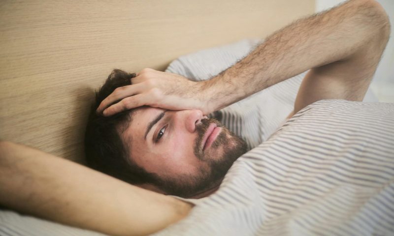 Tired man insomnia head in hands