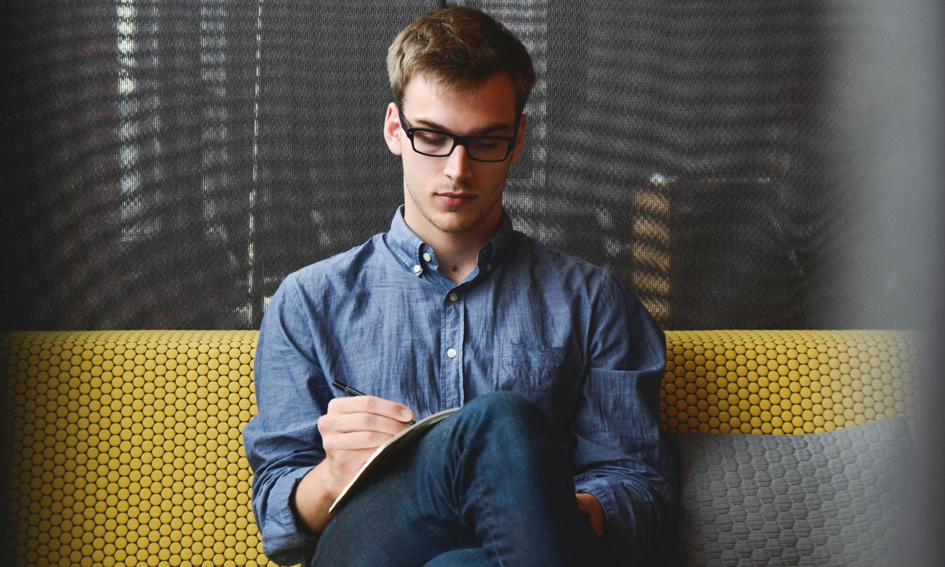 Man writing in journal or book