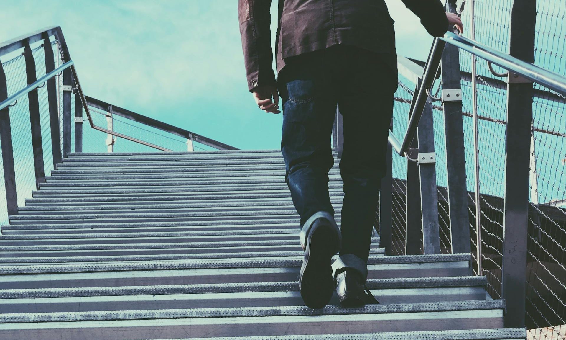 Man climbing walking up steps stairs