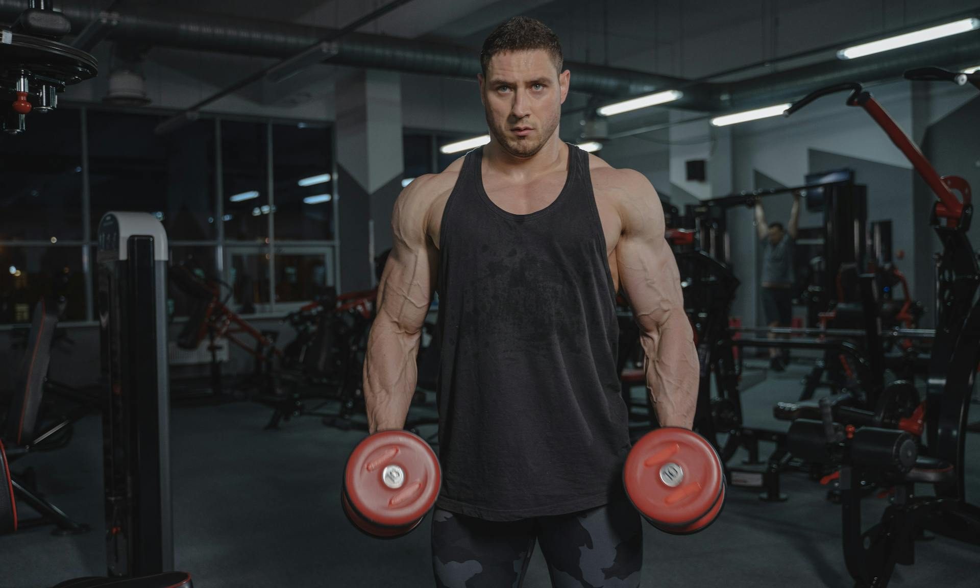 Man in gym holding dumbbells