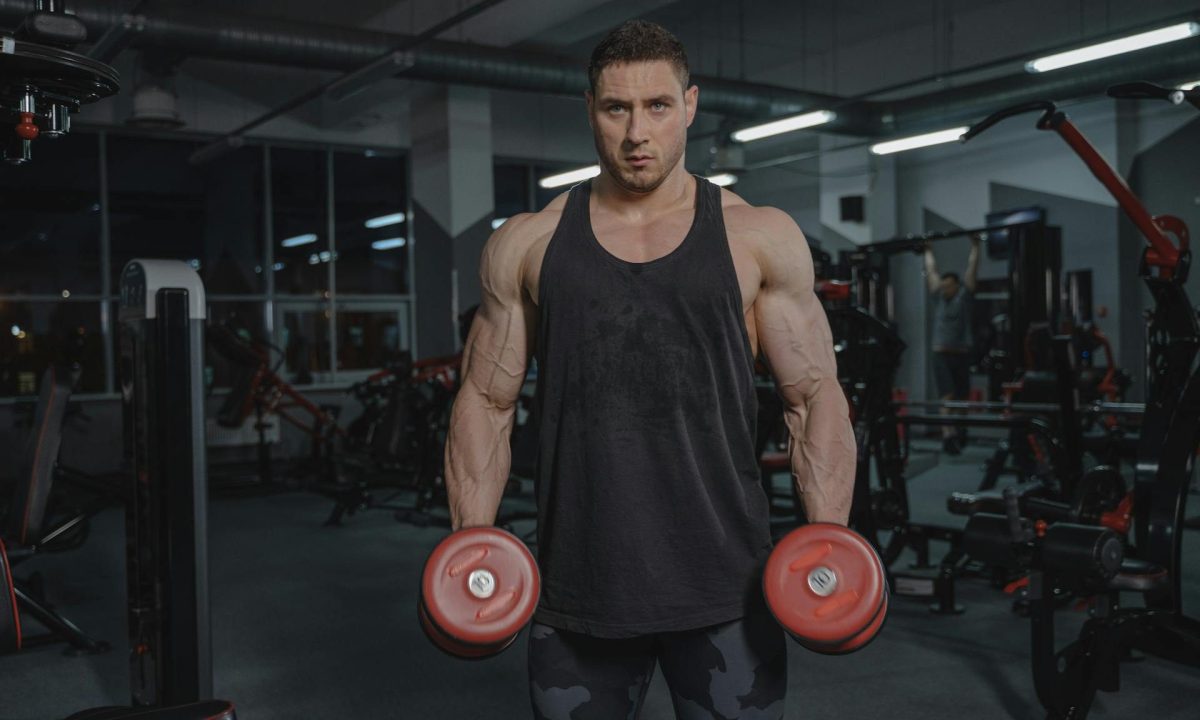 Man in gym holding dumbbells