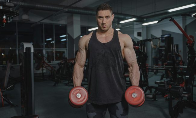 Man in gym holding dumbbells