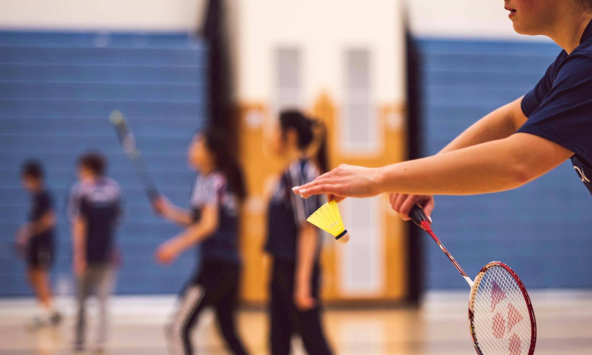 Man playing badminton with shuttlecock