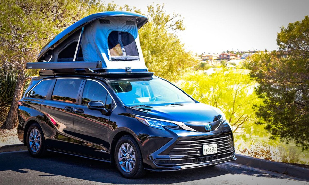 Unicamp Sienna Pop Top Toyota campervan parked on the side of the street with its rooftop tent open.