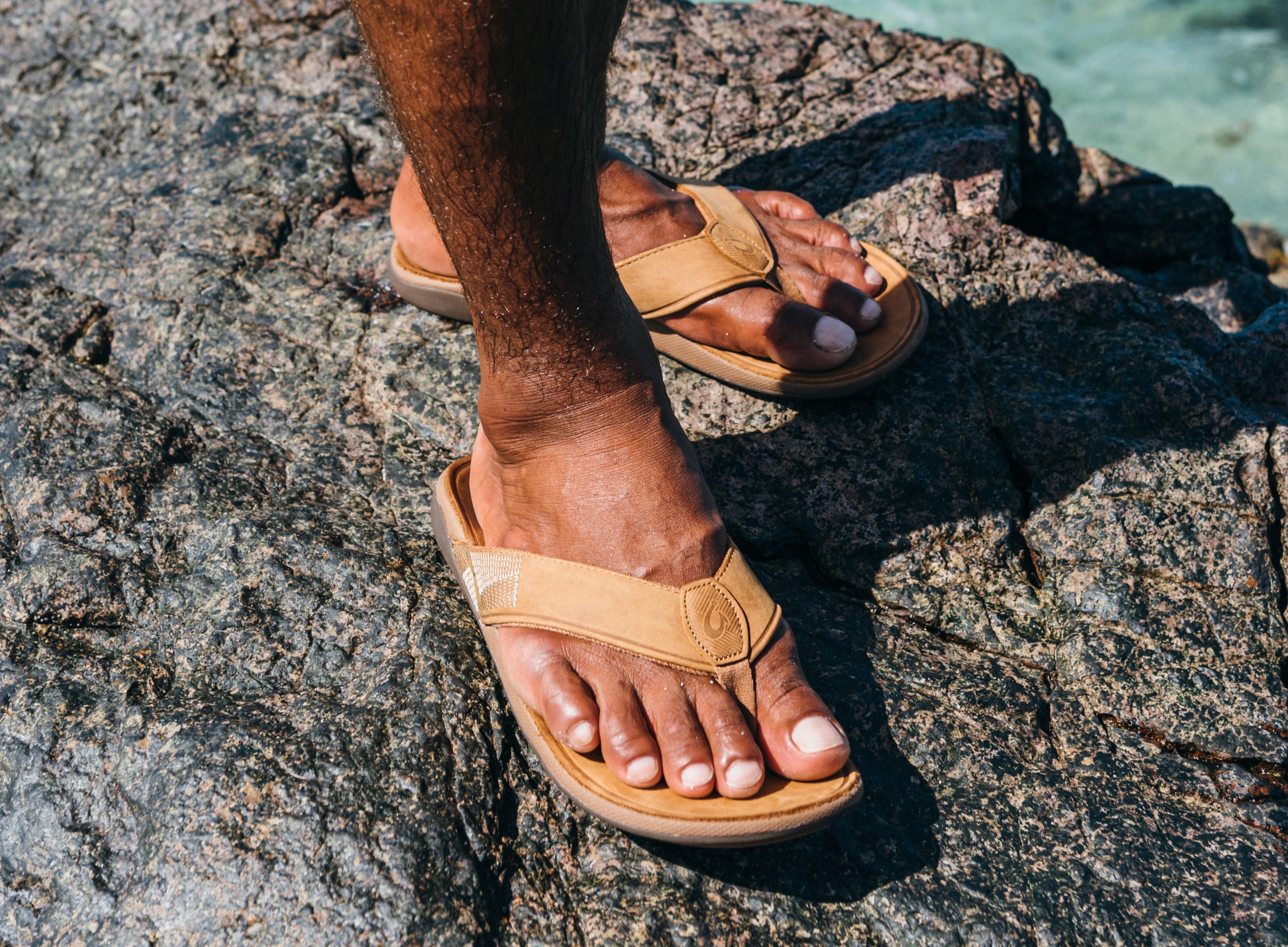 man wearing olukai flip flops