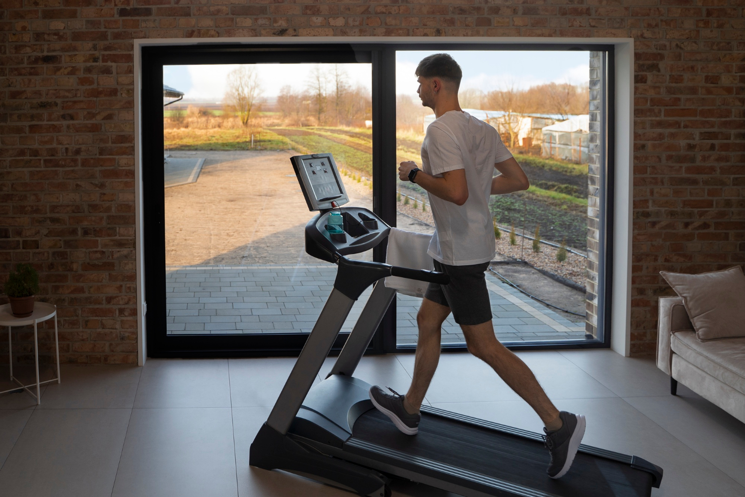 Man walking on incline treadmill.