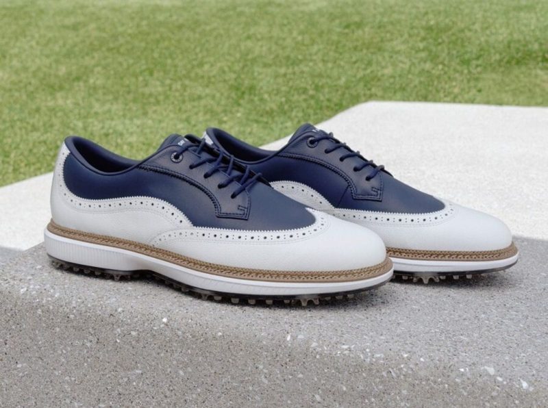 wingtip golf shoes on concrete block