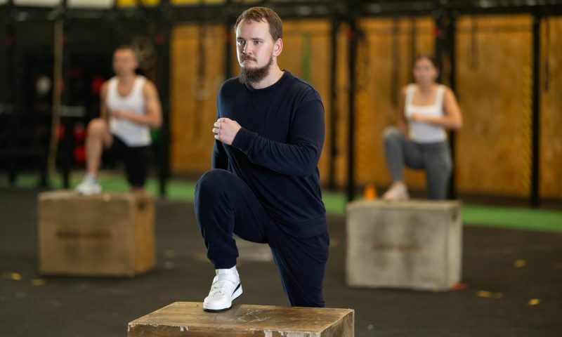 man doing glute step up on box