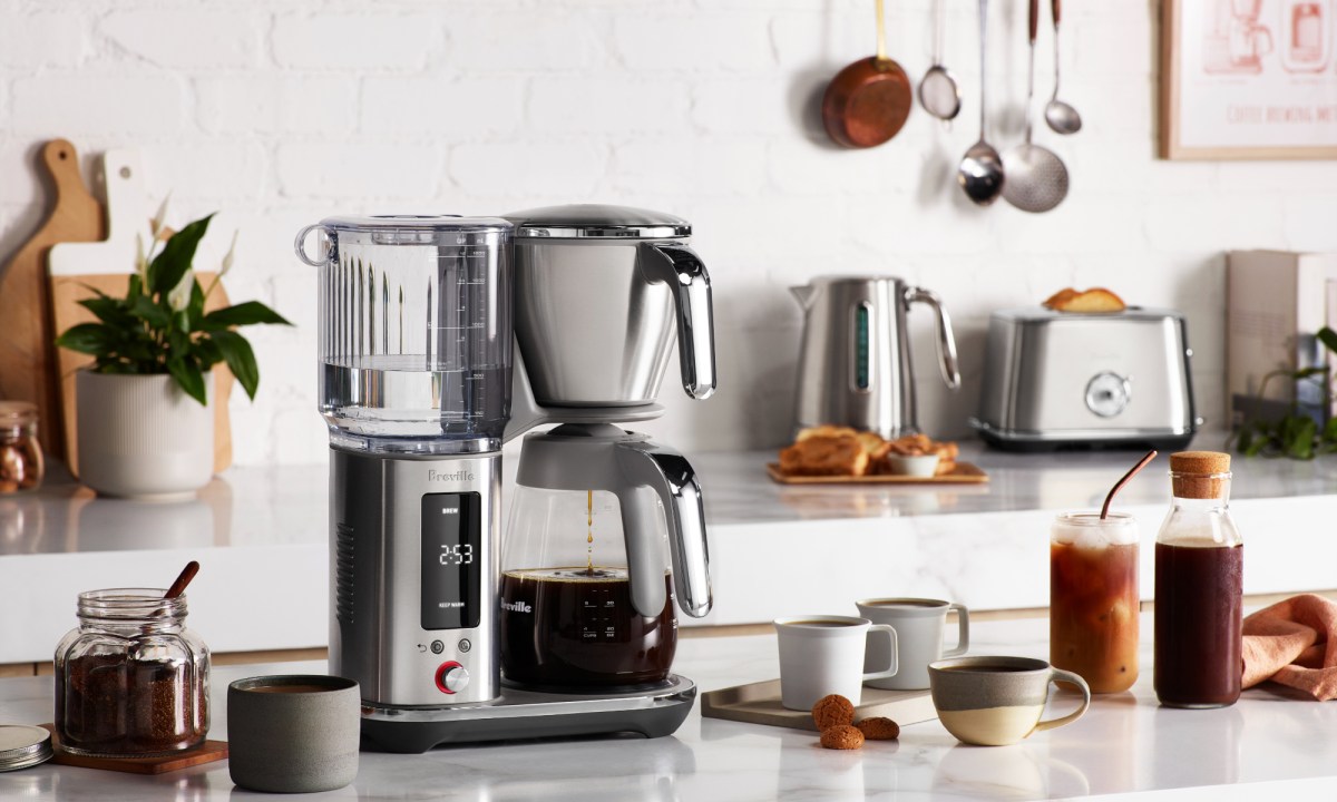 Breville Luxe Brewer with glass carafe on a kitchen counter.