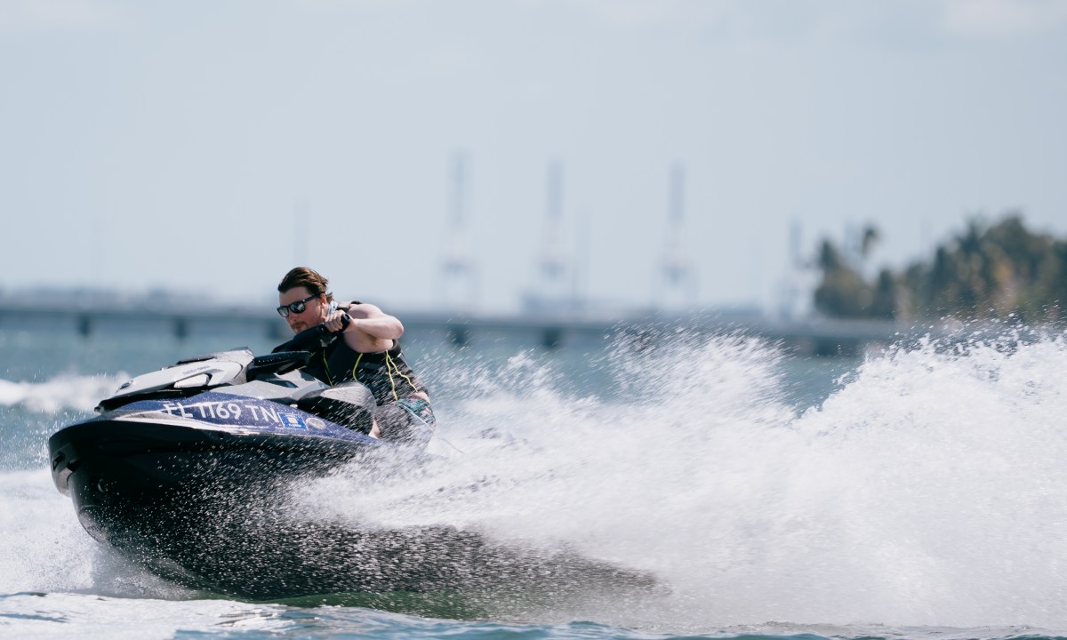 Slightly tubby journalist driving a Sea-Doo PWC at speed