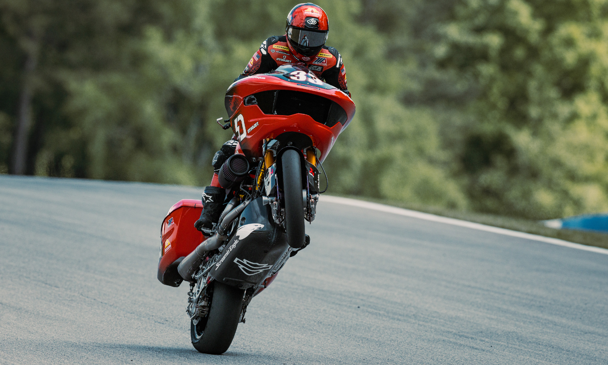 Kyle Wyman doing a wheelie on a Harley-Davidson King of the Baggers factory racer.