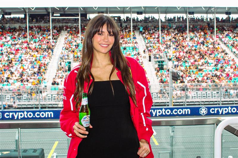Nina Dobrev poses while holding a Peroni.