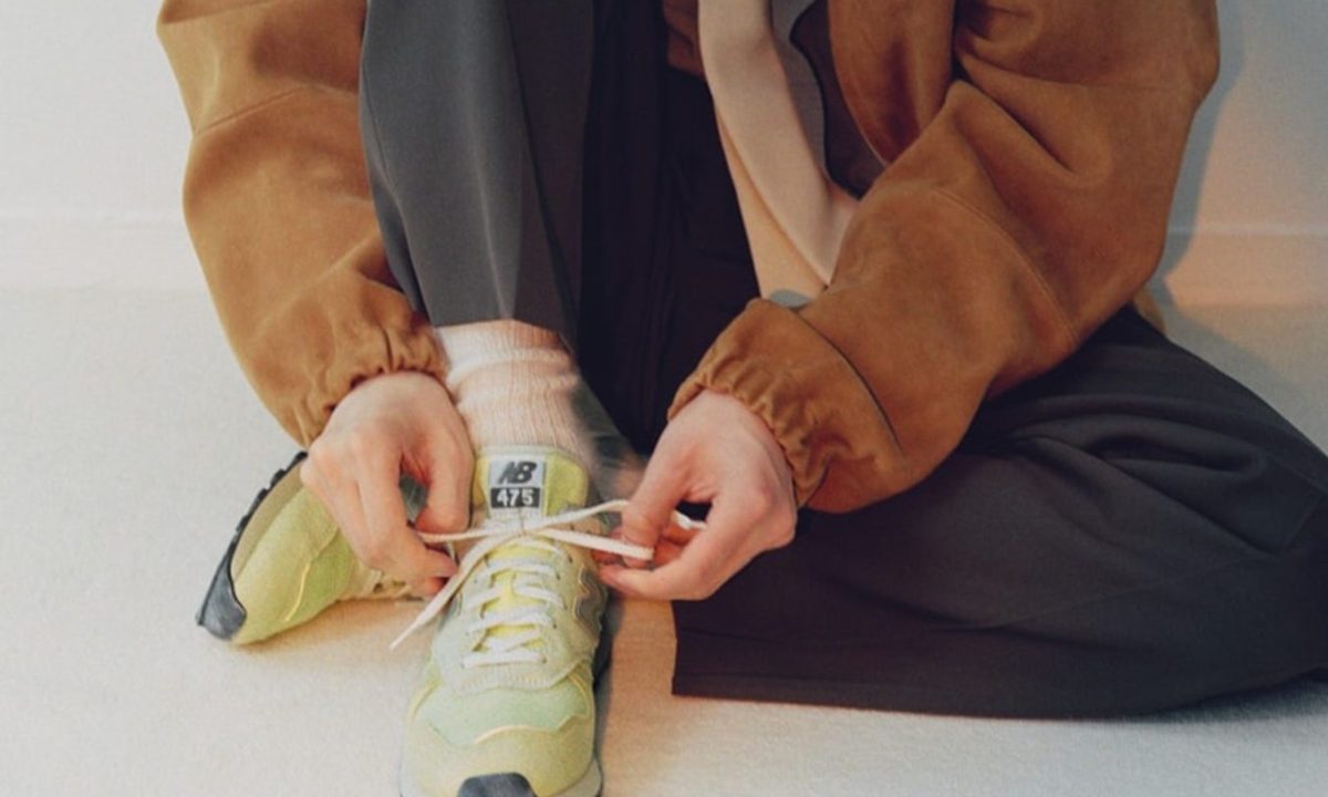 man tying new balance auralee sneaker