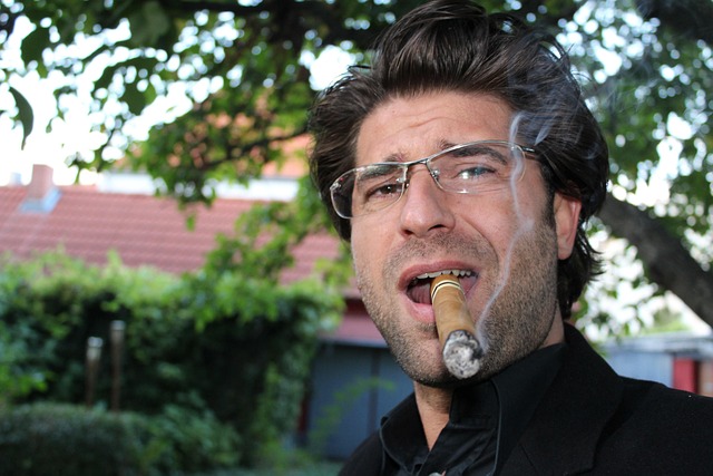 man clenching a cigar in his teeth