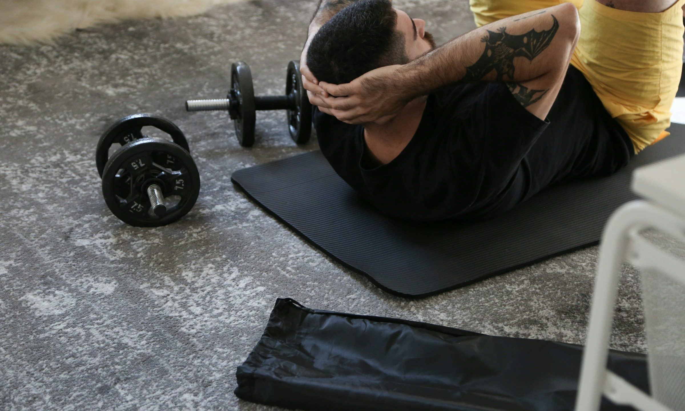 man laying on exercise mat