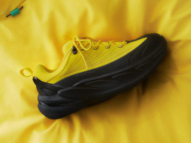 yellow hoka sneaker on satin fabric