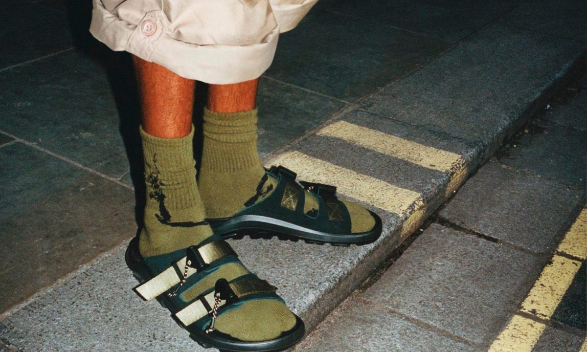 man wearing black maharishi x birkenstock sandals