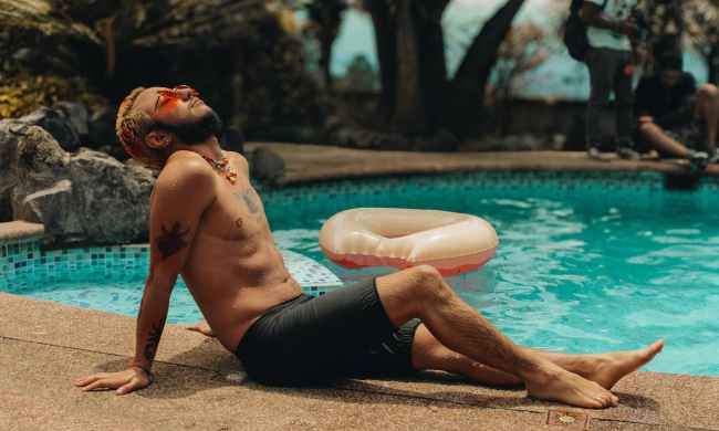 man relaxing in sun sunbathing