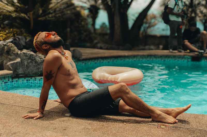 man relaxing in sun sunbathing