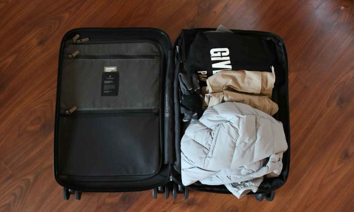 open suitcase with clothes packed inside
