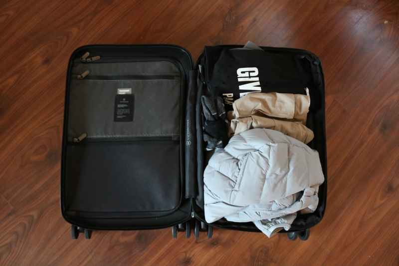 open suitcase with clothes packed inside