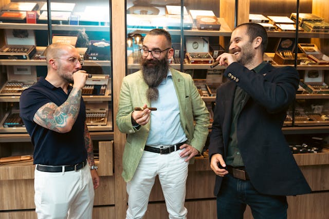 A group of elegant men enjoying cigars