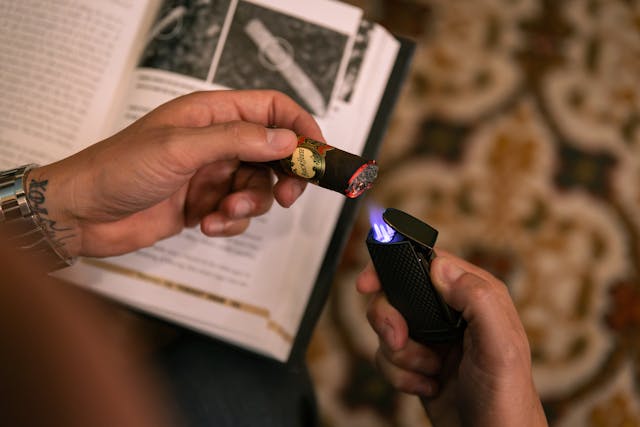 lighting a cigar using a torch lighter