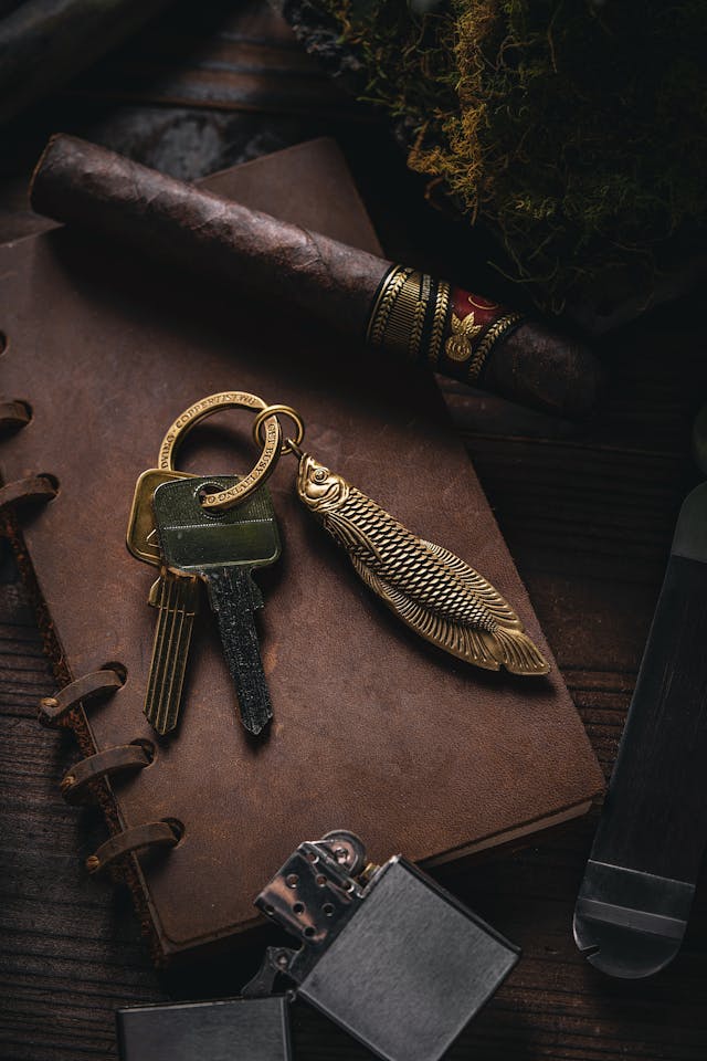 keys, a cigar and lighter on a notebook