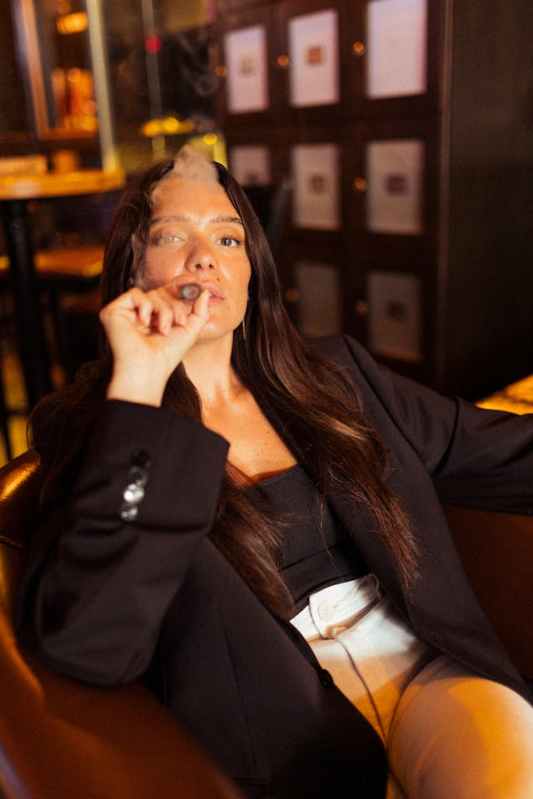 woman smoking a cigar in a lounge