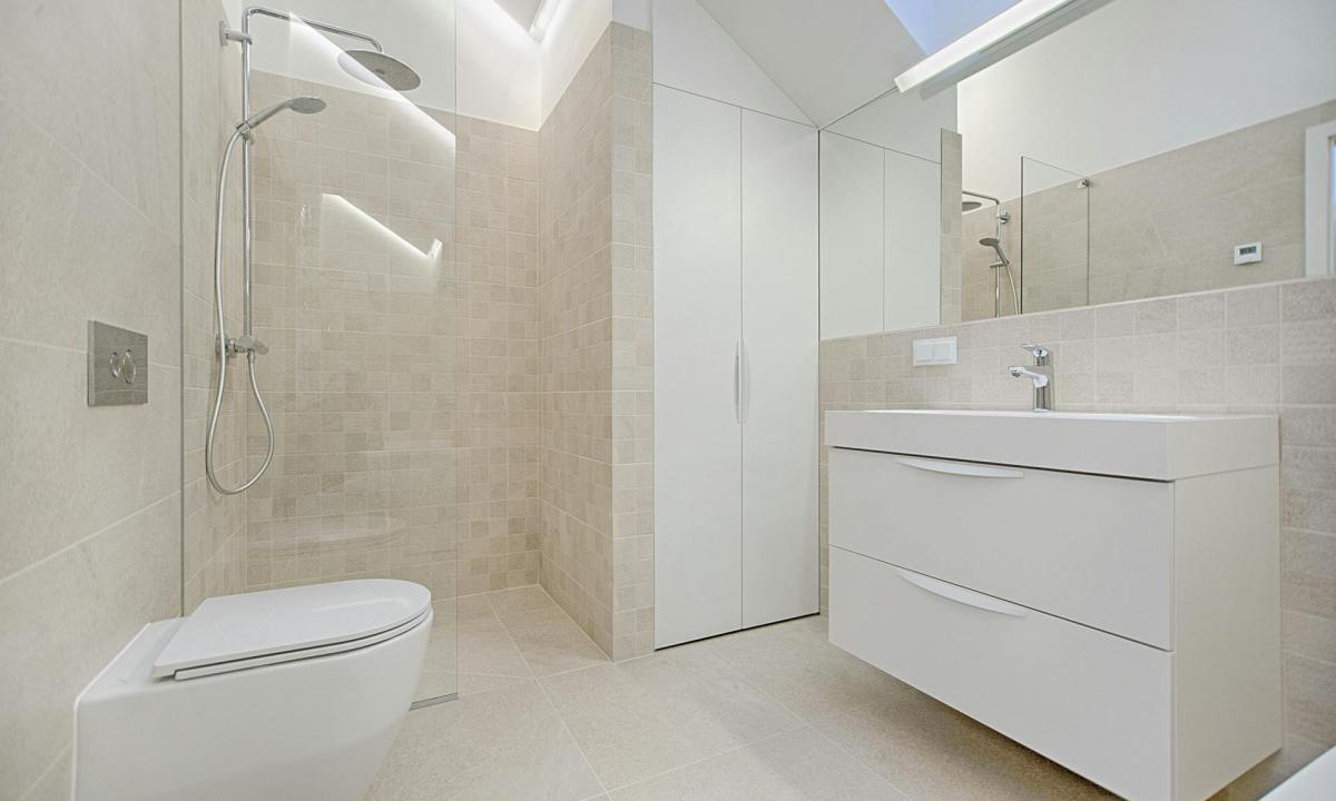 white-washed bathroom with shower, sink and toilet