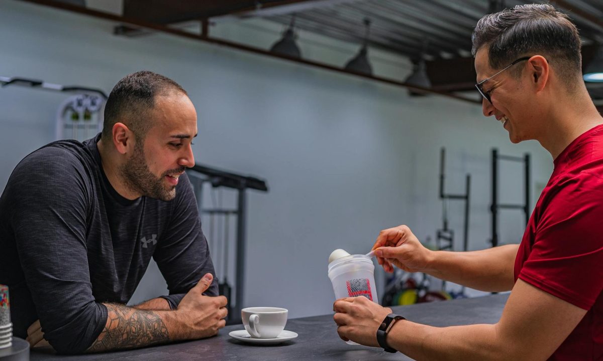 two men smiling friends creatine protein shake powder