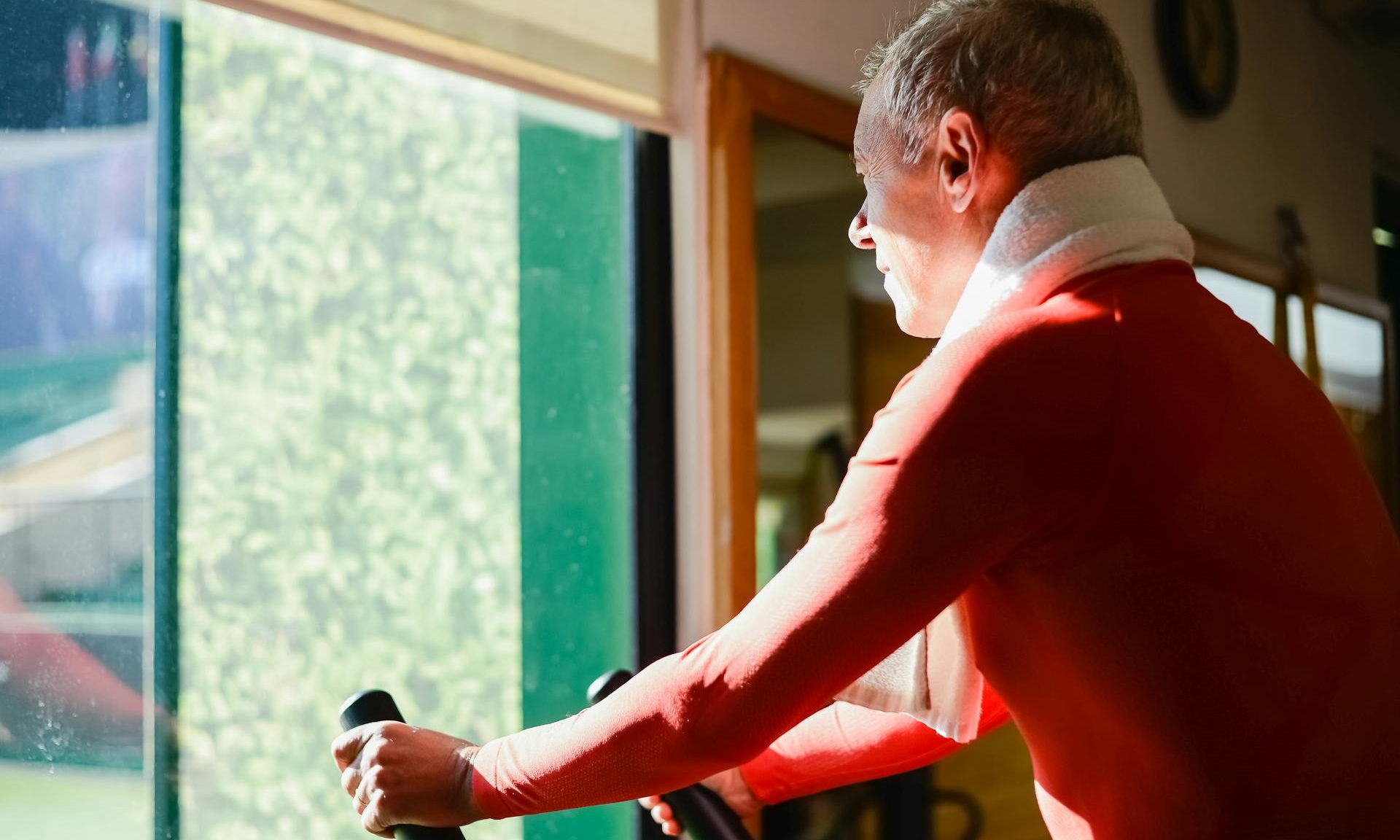Older man exercising cardio exercise bike