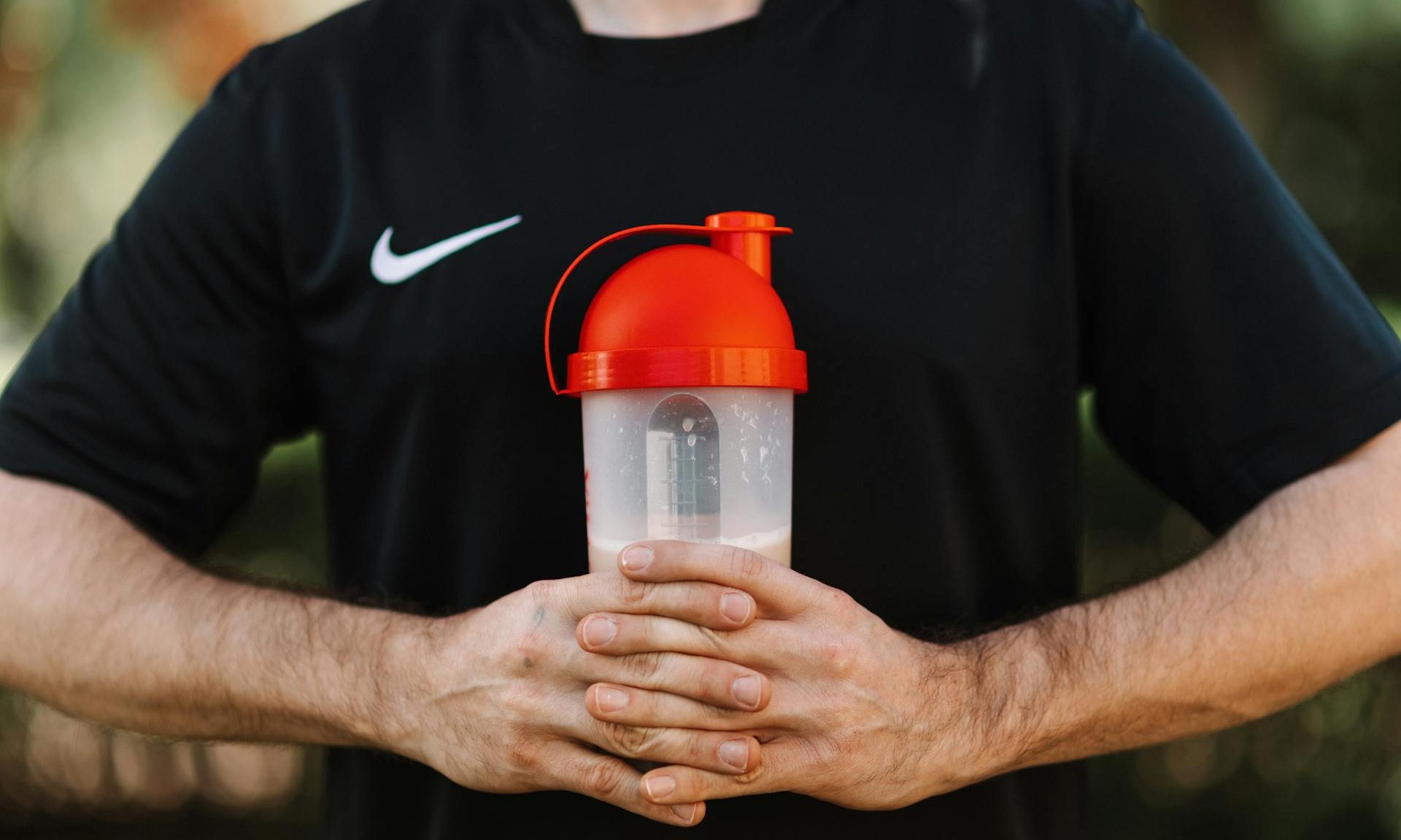 creatine protein shake man holding drink