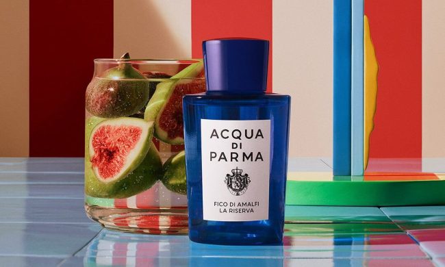 dark blue acqua di parma bottle in front of colorful background