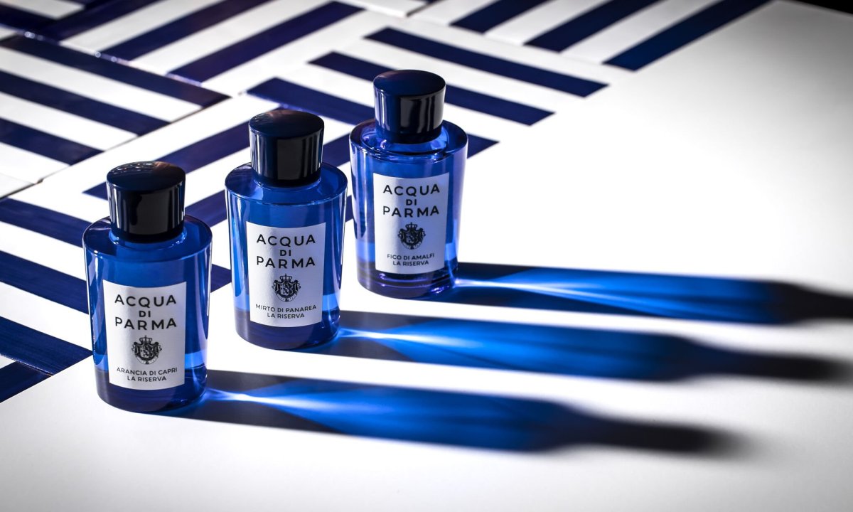 three dark blue acqua di parma fragrance bottles