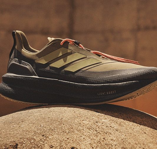 green ultraboost 5 sneaker on concrete