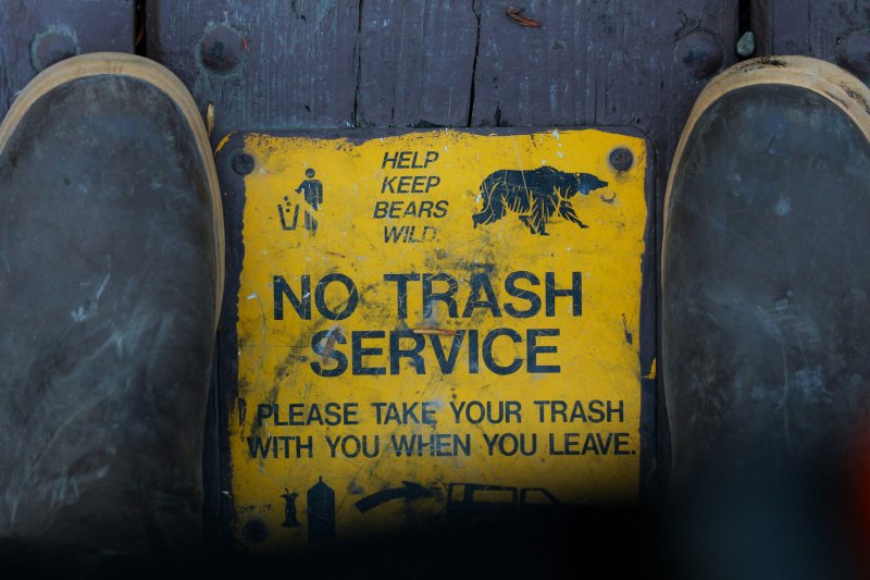 A yellow "No Trash Service" sign in Anchorage, Alaska.
