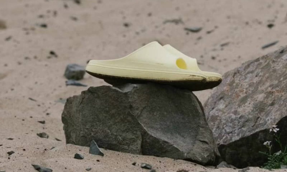 yellow norda sandals on rock