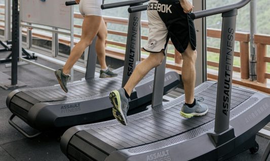 two people walking on incline treadmill