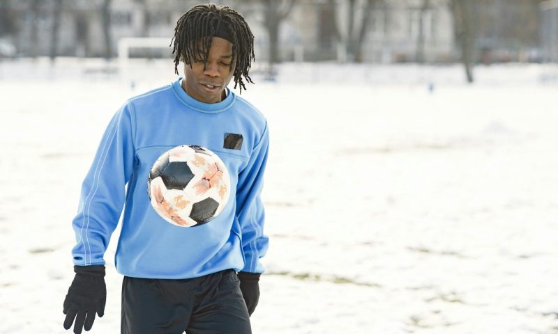 teen playing football