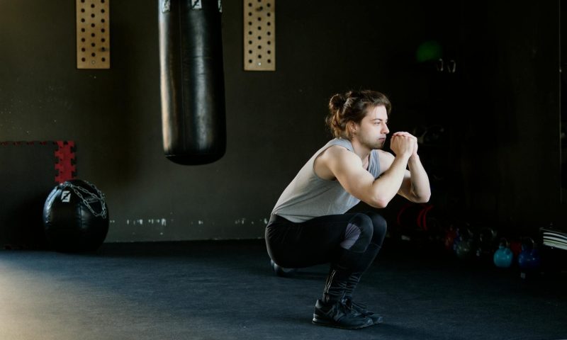 man doing squats HIIT
