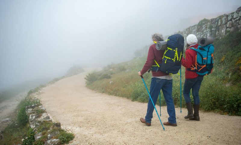 two people with hiking poles