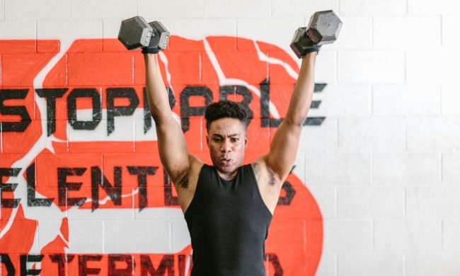 Man lifting dumbbells overhead