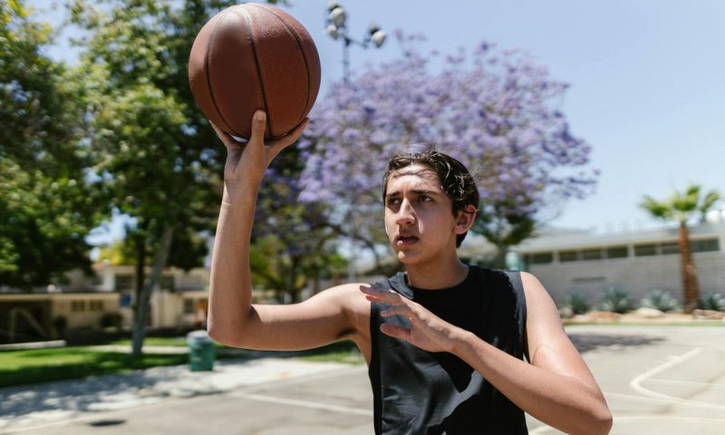 teen playing basketball