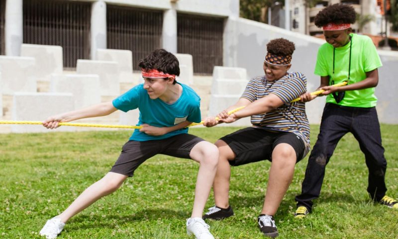-teenage boys pulling rope tugawar