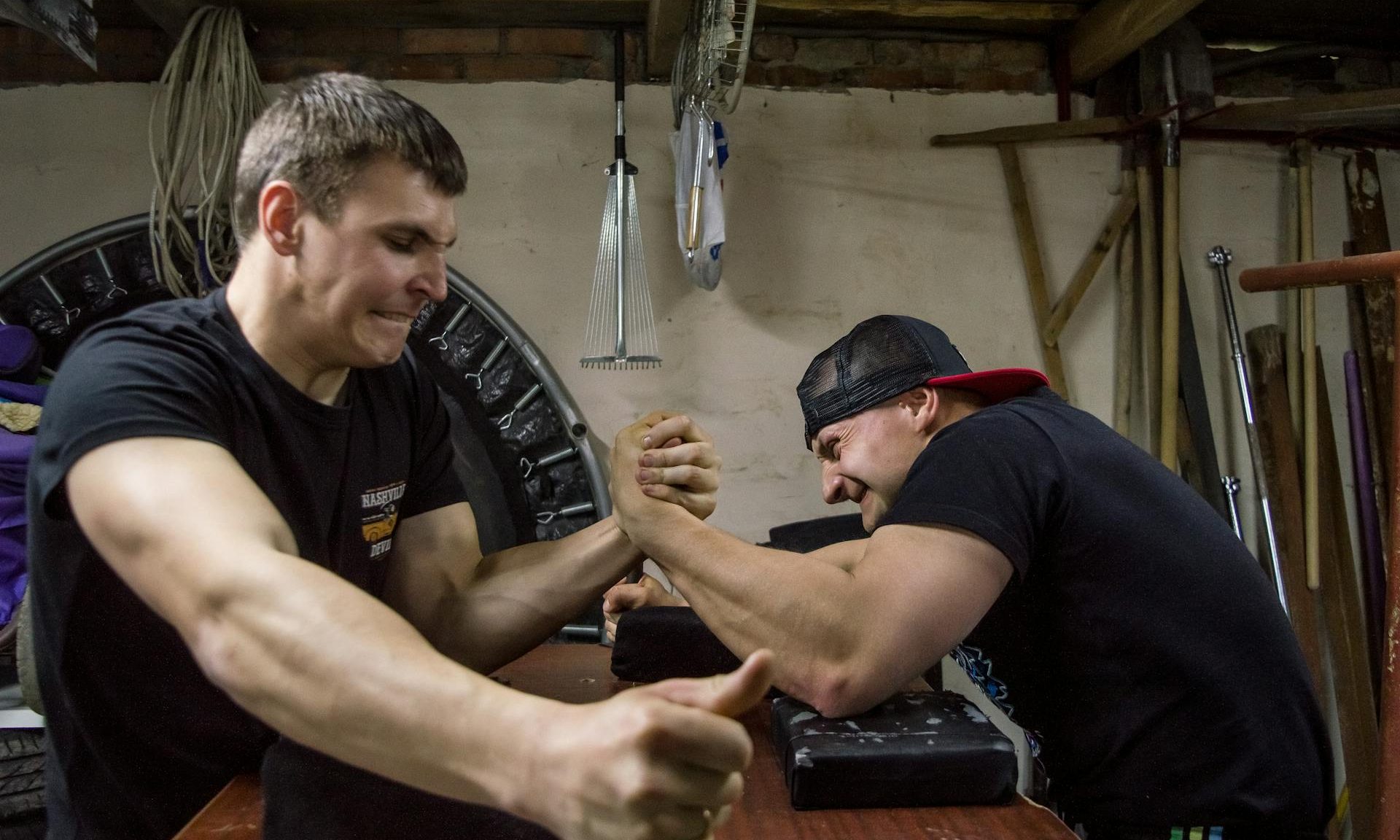 two men arm wrestling strong grip muscles