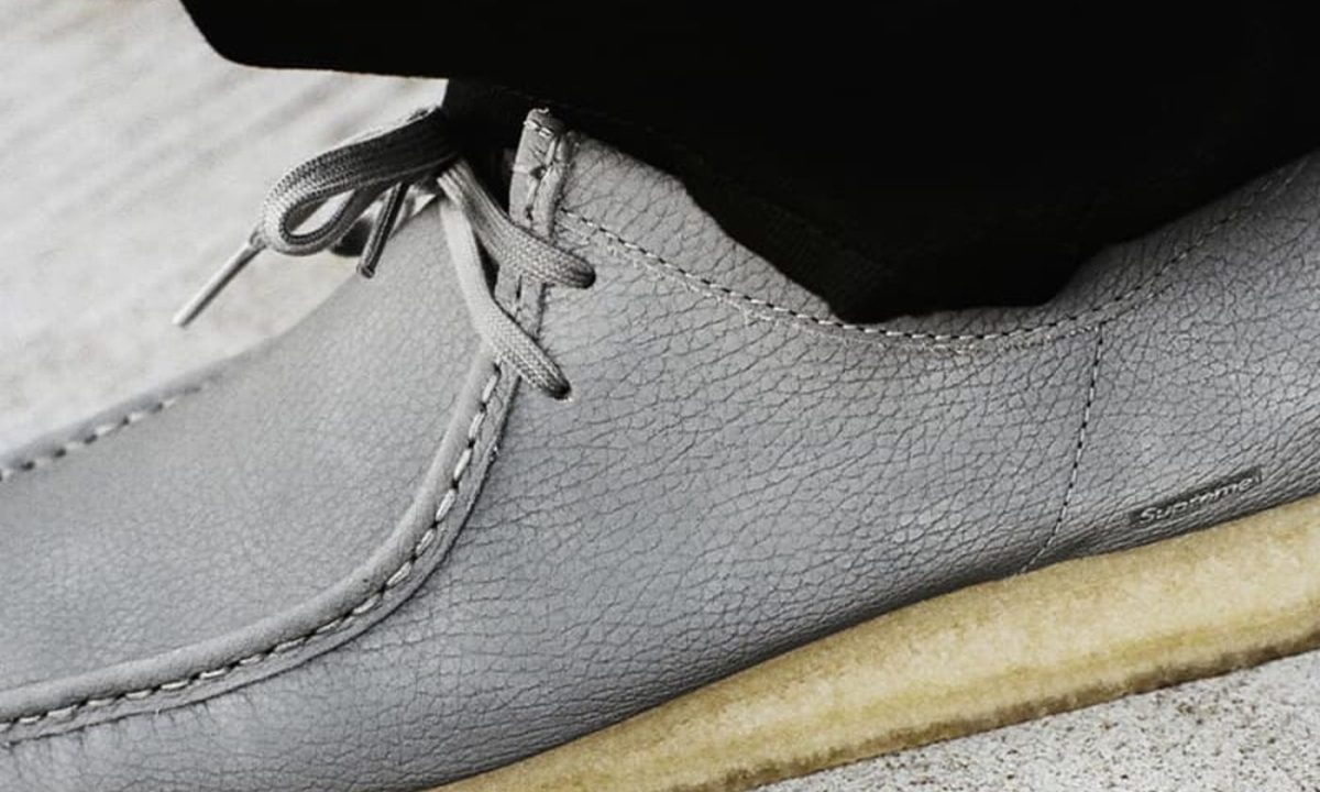 model wearing supreme x clarks shoe