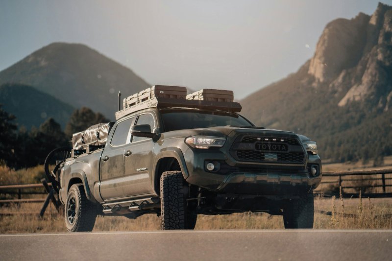 A Toyota Tacoma pickup truck parked and packed for overlanding.