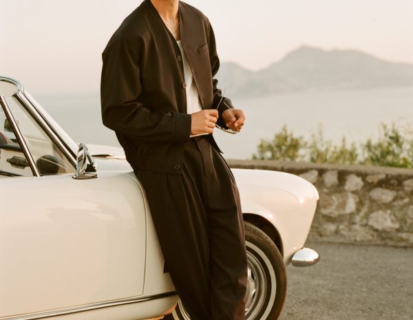man leaning against car wearing kith x armani
