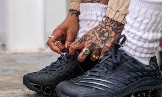 person tying adidas shoes